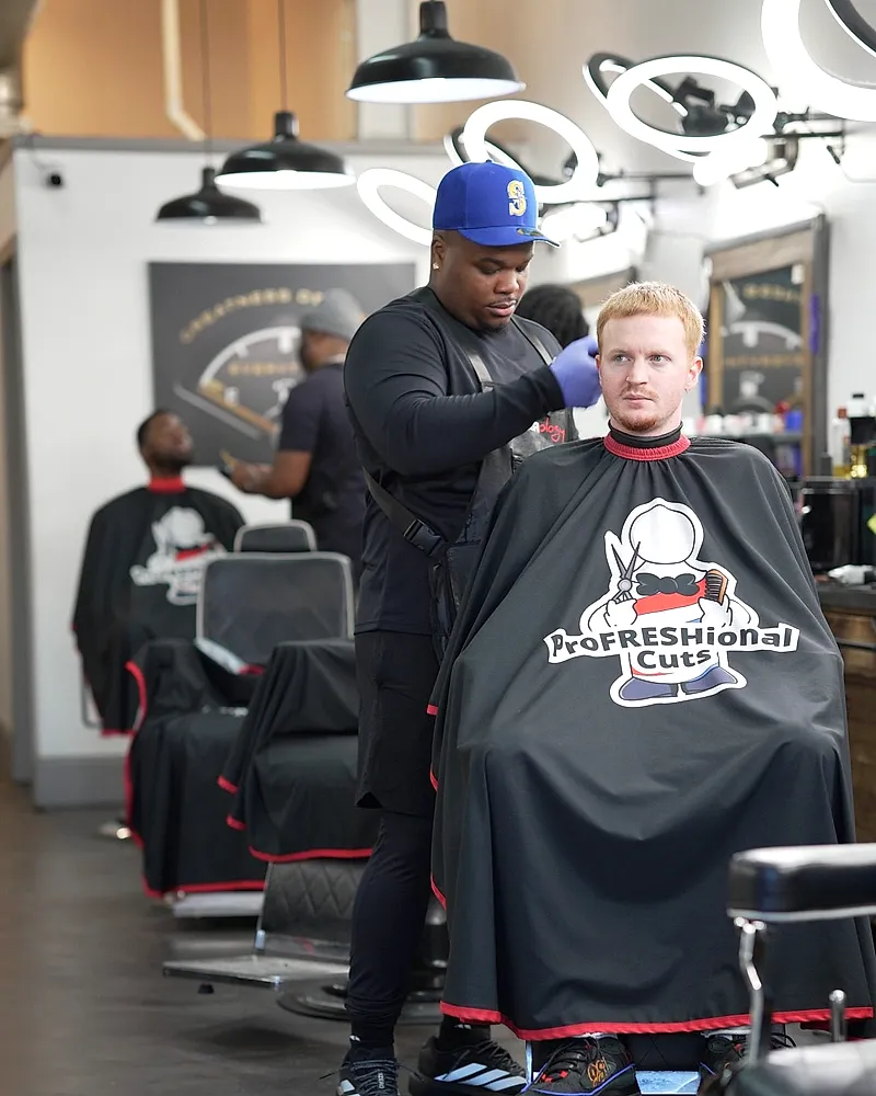 A barber detailing a client's cut